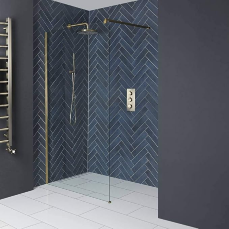 A modern bathroom featuring blue tiles, a glass shower, and an antique brass shower screen for an elegant touch.